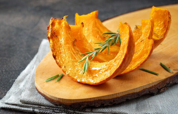 Kürbisschnitze aus dem Ofen mit Thymian garniert.
