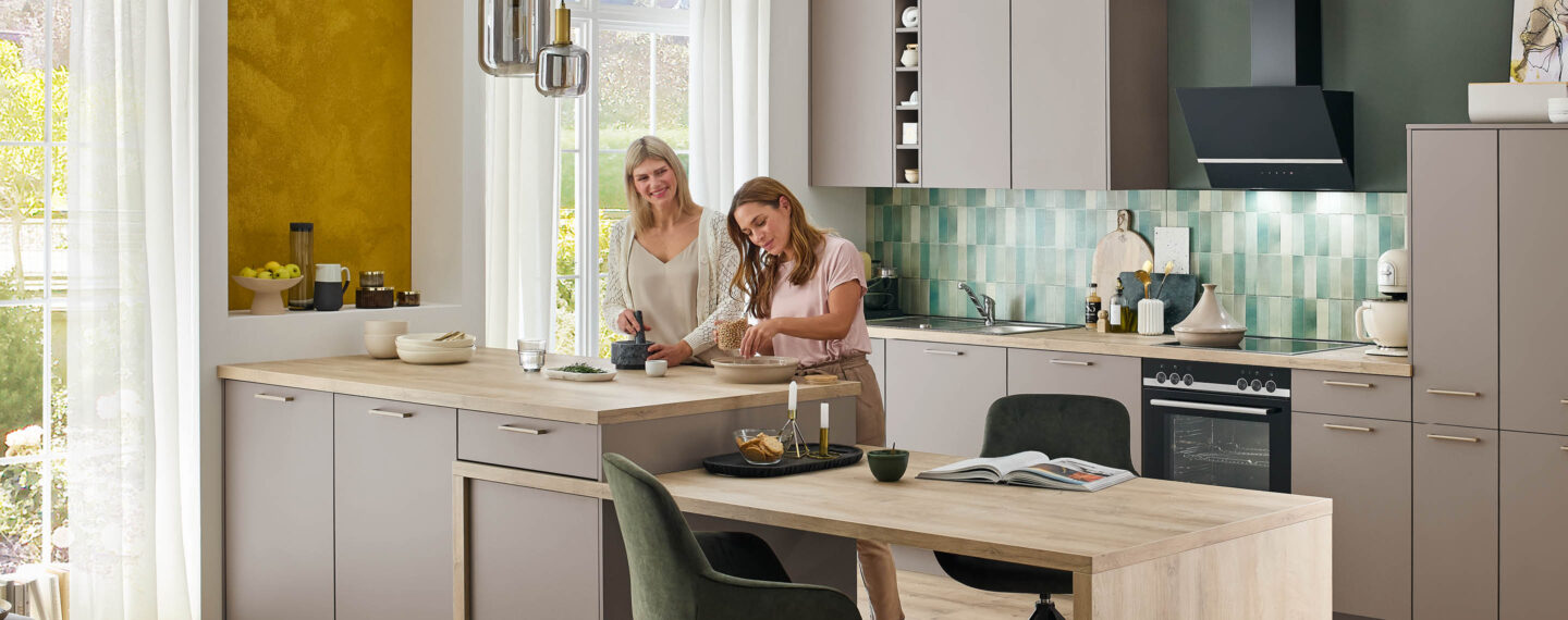 zwei Frauen bereiten Essen zu in einer modernen Küche von nobilia